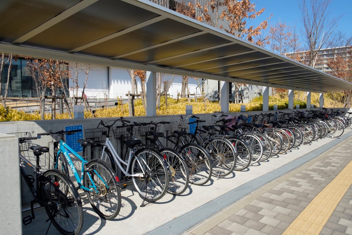 A line of parked bicycles under an awning
