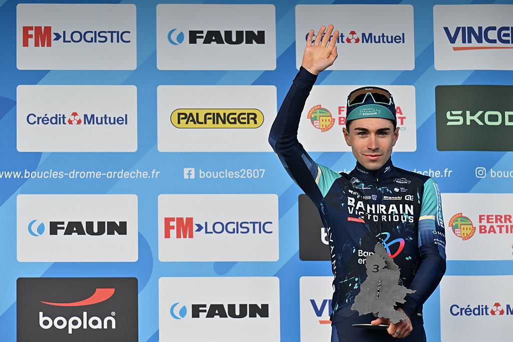 Lenny Martinez waves from the podium before the other two arrive after finishing third in the Faun Drome Classic