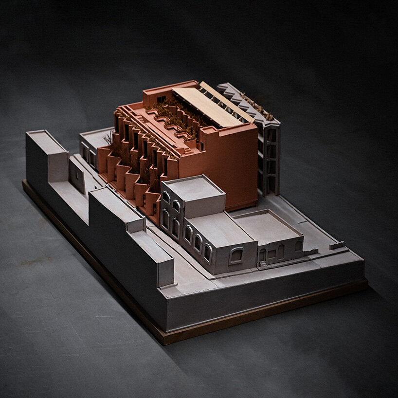 physical model shows the stepped volume integrated within the surrounding urban fabric