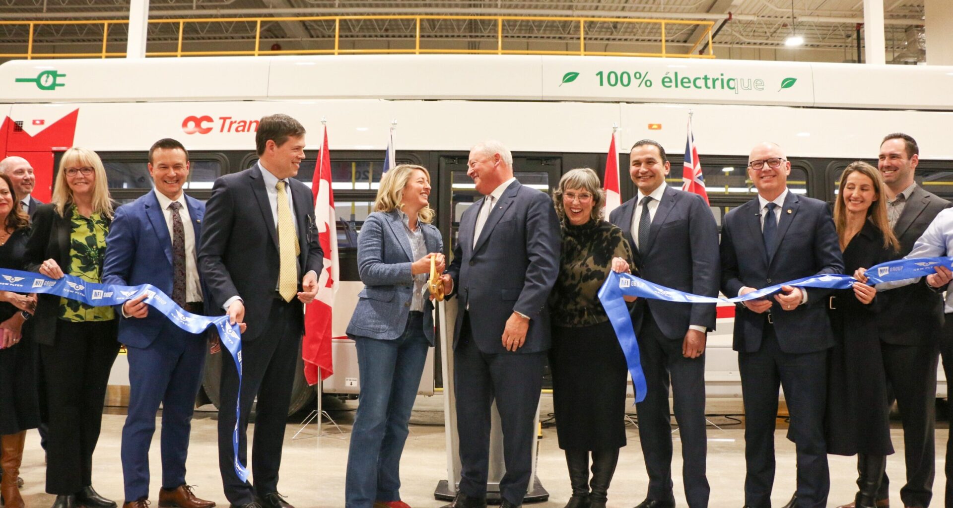A group of people celebrating a ribbon cutting