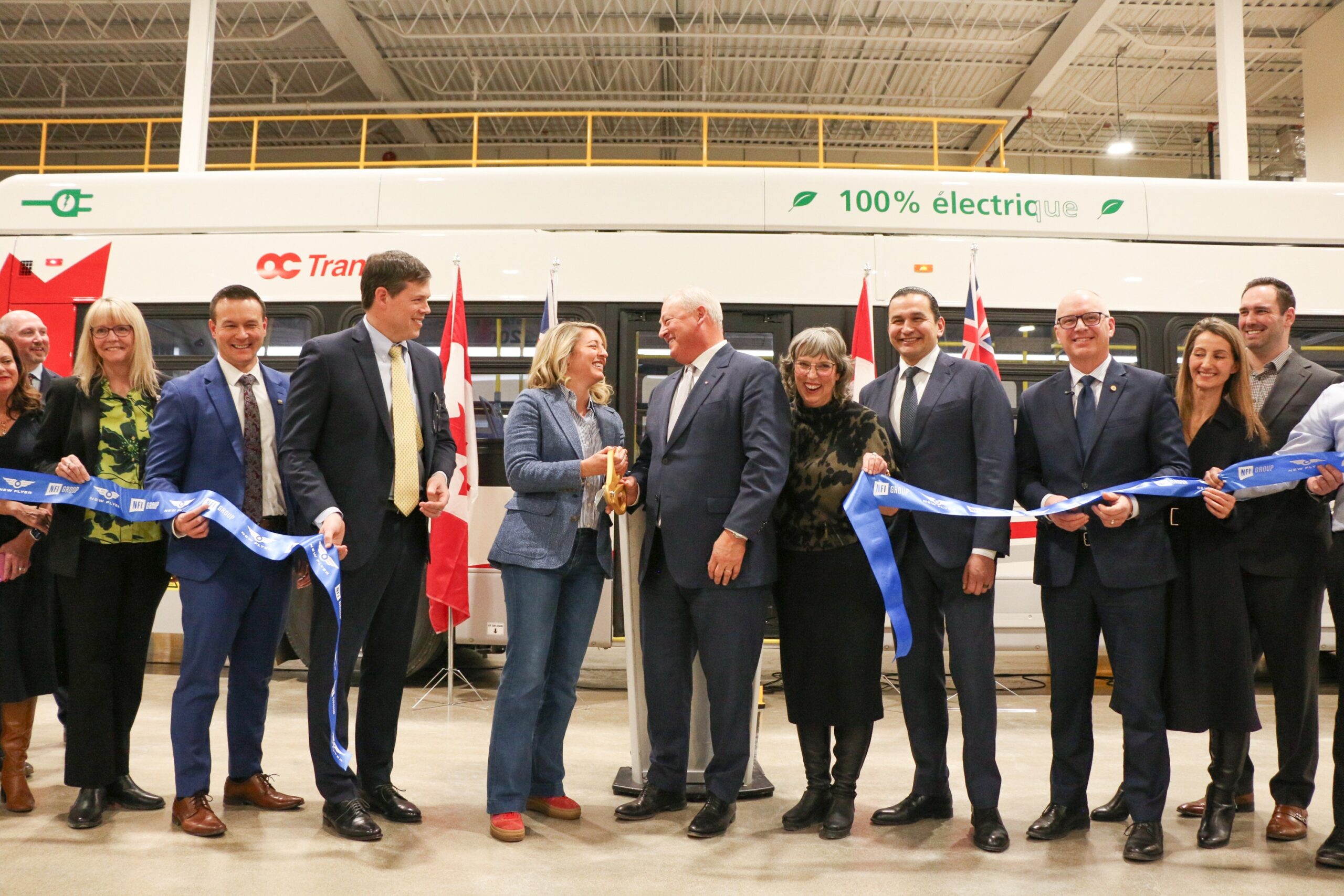 A group of people celebrating a ribbon cutting