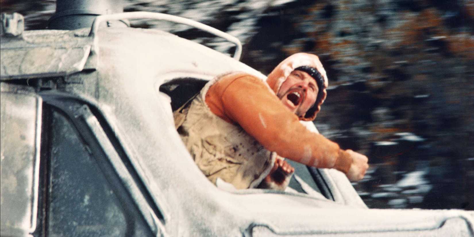 Jon Voight coming out of a moving car window in Runaway Train
