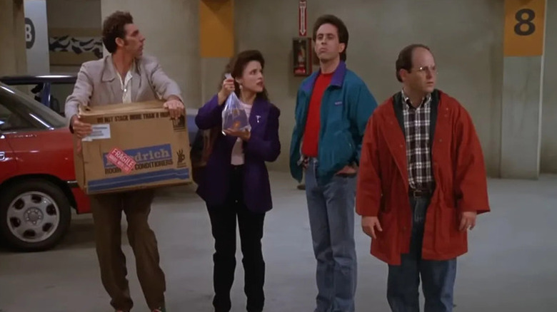 Kramer, Elaine, Jerry, and George looking around a parking garage in Seinfeld