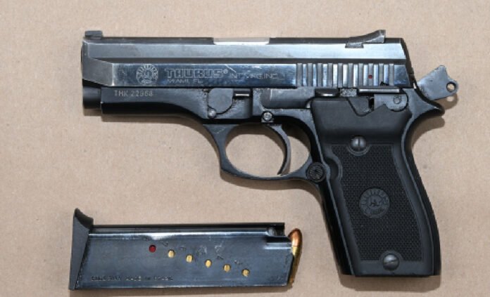 A silver Taurus semi-automatic handgun with a black grip is shown beside a detached magazine containing several rounds of ammunition, displayed as seized evidence.