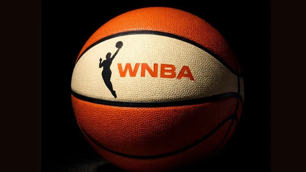Generate a basketball with the WNBA logo^ the background must be completely black but the ball must be illuminated artistically.