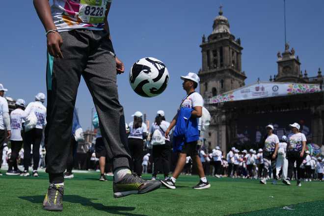 Mexico City People practice soccer skills in an attempt to set a Guinness World Record for the "largest soccer class" at the Zocalo in Mexico City, Sunday, March 15, 2026.