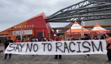 Why did Jeju soccer fans hold anti-racism placards before match?