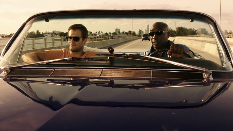 Walter Sherman sits next to Leo Knox as they ride in a car on The Finder (2012)