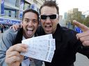 Cliff Truman and Nick Euler show off their tickets during a sellout at the Rogers Centre for the opening game of the Toronto Blue Jays in Toronto April 9, 2012. 