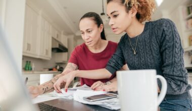 Two adults looking at financial paperwork.
