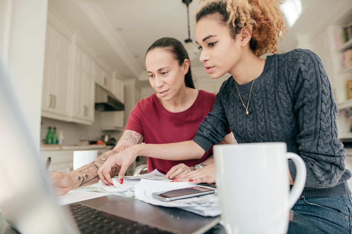 Two adults looking at financial paperwork.