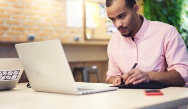An investor works on a laptop in an office.