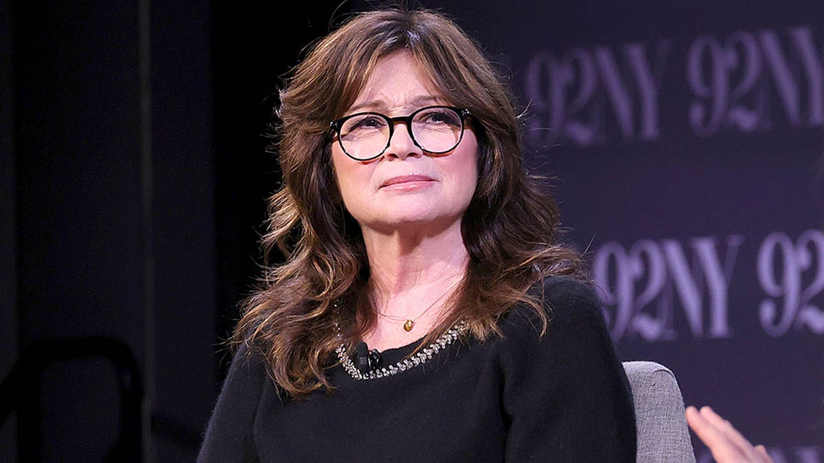 Valerie Bertinelli frowns onstage while having a conversation with Drew Barrymore
