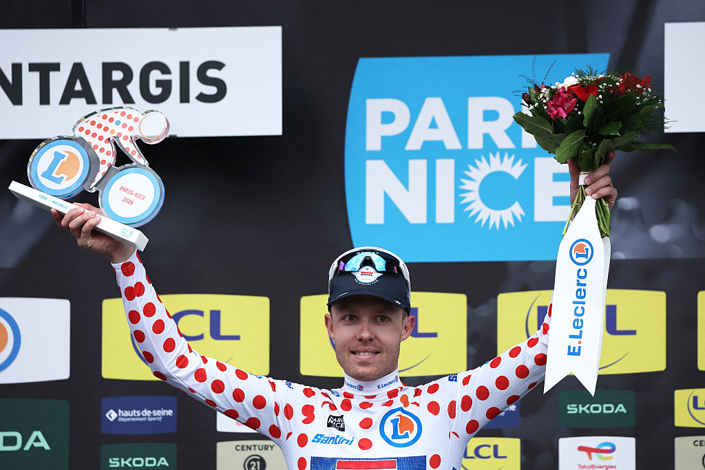Soudal Quick-Step's Danish rider Casper Pedersen celebrates his white with red polka dots jersey for best climber on the podium after the 2nd stage of the Paris-Nice cycling race, 187 km between &Eacute;p&ocirc;ne and Montargis, on March 9, 2026. (Photo by Anne-Christine POUJOULAT / AFP)