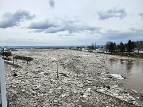 Chunks of ice cover Bayfield Street in Meaford Saturday afternoon after an ice jam caused the Bighead River to flow over the retaining wall. Workers used backhoes to clear the ice and restore the river's flow. Photo supplied by Vanessa Knight
