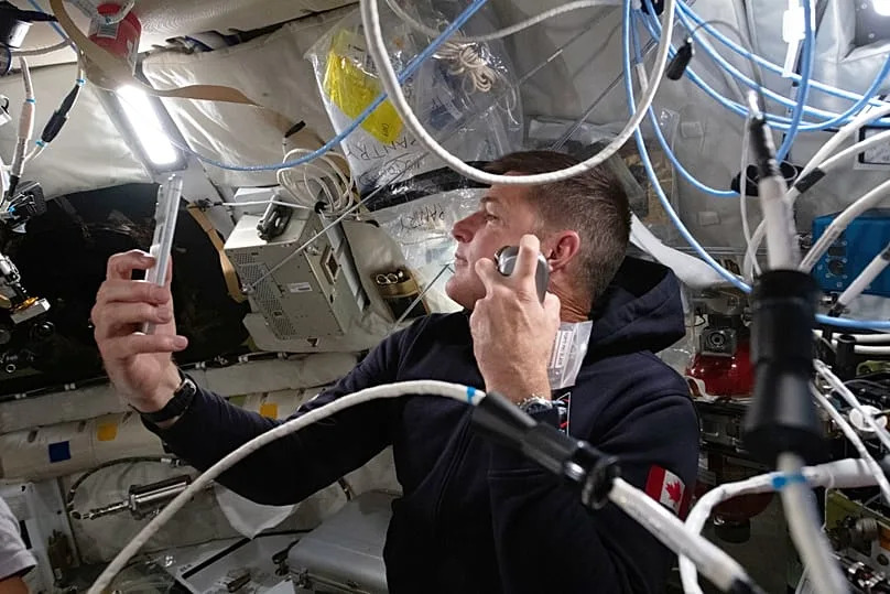 Artemis II mission specialist Jeremy Hansen enjoys a shave inside the Orion spacecraft during Flight Day 5 and ahead of the crew's lunar flyby, Monday, April 6, 2026.