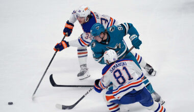 Apr 8, 2026; San Jose, California, USA;  Edmonton Oilers center Colton Dach (34) and Edmonton Oilers center Joshua Samanski (81) battle San Jose Sharks left wing Igor Chernyshov (92) for the puck in the third period at SAP Center at San Jose. Mandatory Credit: David Gonzales-Imagn Images