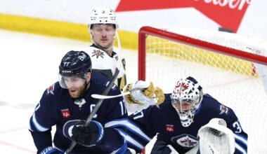 Mar 24, 2026; Winnipeg, Manitoba, CAN; Winnipeg Jets center Adam Lowry (17) and Vegas Golden Knights center Jack Eichel (9) tie up sticks in front of Winnipeg Jets goaltender Connor Hellebuyck (37) in the third period at Canada Life Centre. Mandatory Credit: James Carey Lauder-Imagn Images