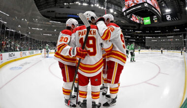 Apr 7, 2026; Dallas, Texas, USA; Calgary Flames defenseman Zayne Parekh (19) and left wing Blake Coleman (20) and right wing Matvei Gridin (92) celebrates after Parekh scores a power-play goal against the Dallas Stars during the third period at the American Airlines Center. Mandatory Credit: Jerome Miron-Imagn Images