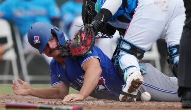 Mar 16, 2026; Jupiter, Florida, USA;  Toronto Blue Jays second baseman Davis Schneider (36) scores a run as Miami Marlins catcher Brian Navarreto (64) drops the ball at the plate in the third inning at Roger Dean Chevrolet Stadium. Mandatory Credit: Jim Rassol-Imagn Images
