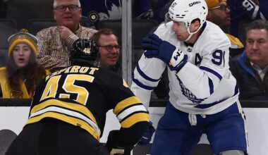 Mar 24, 2026; Boston, Massachusetts, USA; Toronto Maple Leafs center John Tavares (91) eyes a loose puck over the head of Boston Bruins defenseman Jonathan Aspirot (45) during the first period at TD Garden. Mandatory Credit: Winslow Townson-Imagn Images