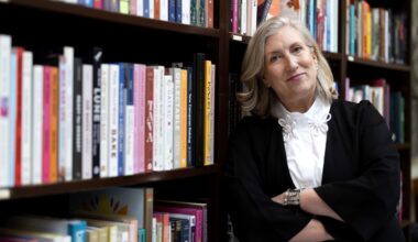 Food writer Lesley Chesterman leans against a bookcase in a bookstore.