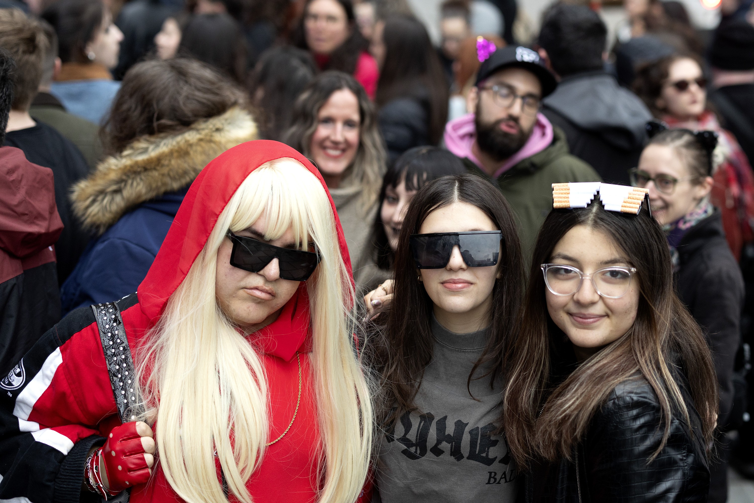 Lady Gaga fans pose and other mill around outside a concert in Montreal. 
