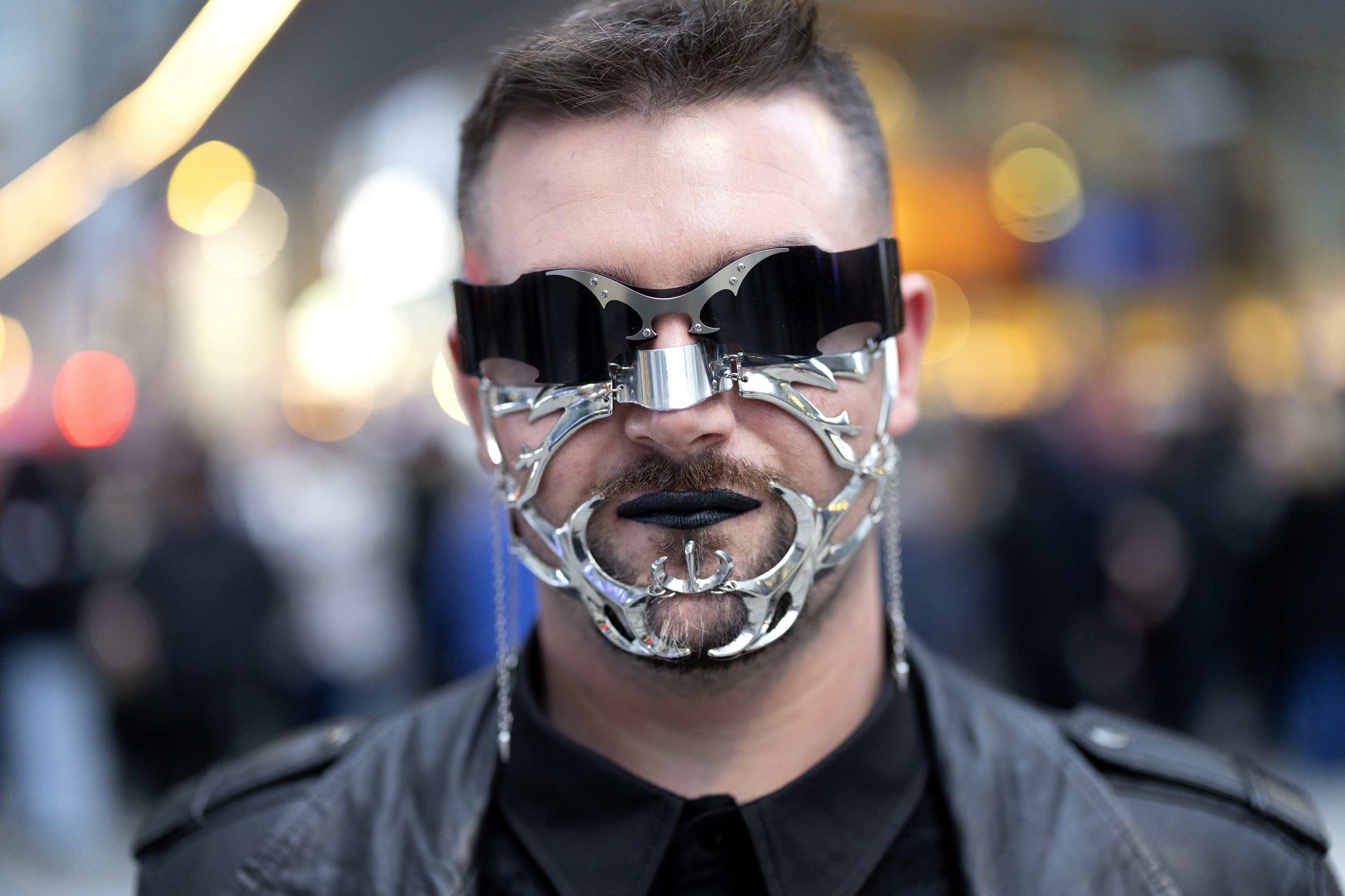A Lady Gaga concertgoer wears a metallic face covering. 