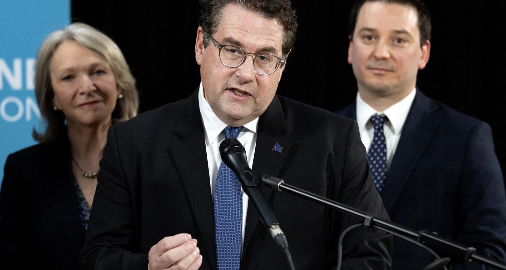 Bernard Drainville speaks to the media as Sonia Bélanger and Simon Jolin-Barrette look on in Montreal on Monday, April 6, 2026.