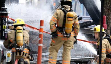 Montreal firefighters spray down the remains of a small building.