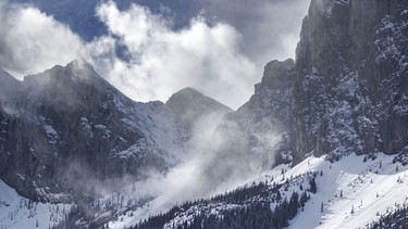 Wind-blown snow rolls off the shoulder of Yamnuska east of Exshaw, Ab., on Tuesday, April 7, 2026.