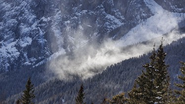 Wind-blown snow catches the sun below Yamnuska east of Exshaw, Ab., on Tuesday, April 7, 2026.