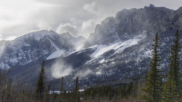 Wind-blown snow comes off Yamnuska and the peaks east of Exshaw, Ab., on Tuesday, April 7, 2026.