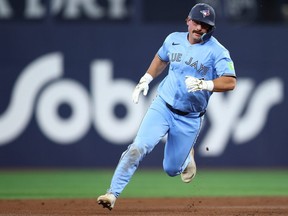 Davis Schneider of the Toronto Blue Jays runs to third base