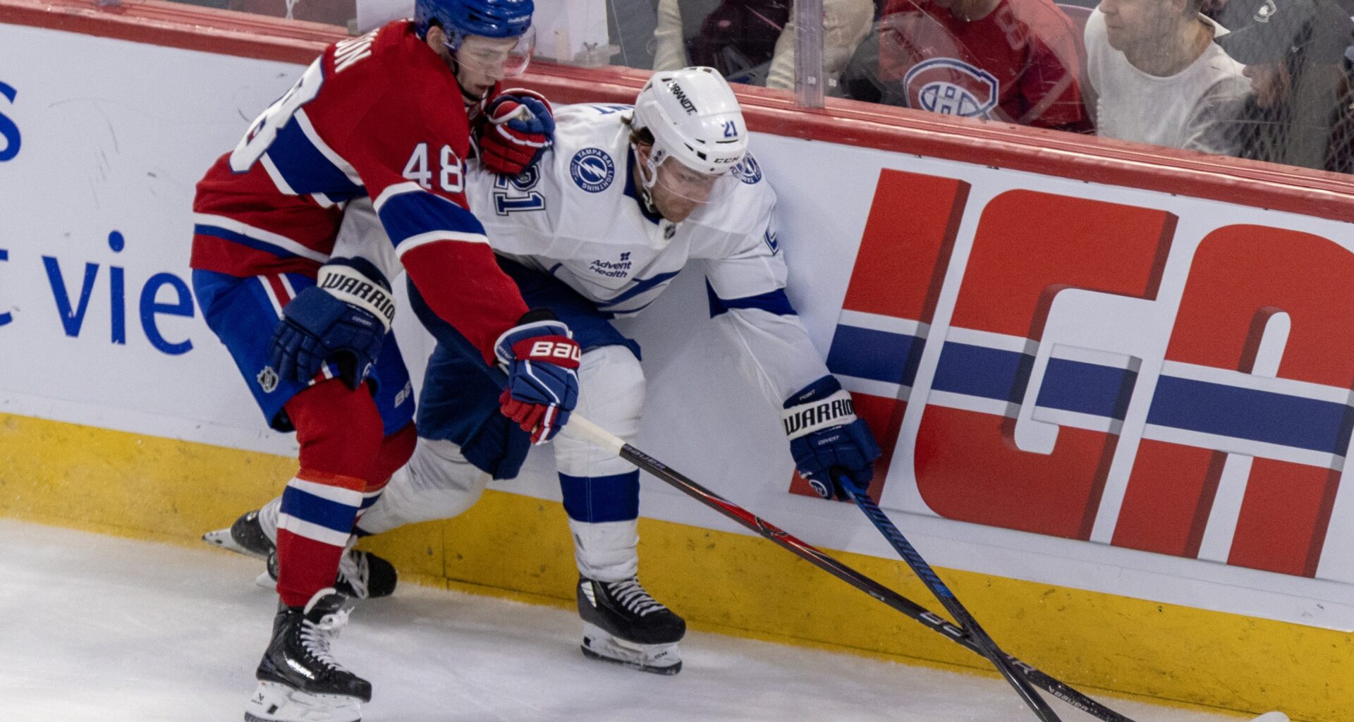 Montreal Canadiens' Lane Hutson pokes the puck away from Tampa Bay Lightning Brayden Point