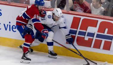 Montreal Canadiens' Lane Hutson pokes the puck away from Tampa Bay Lightning Brayden Point