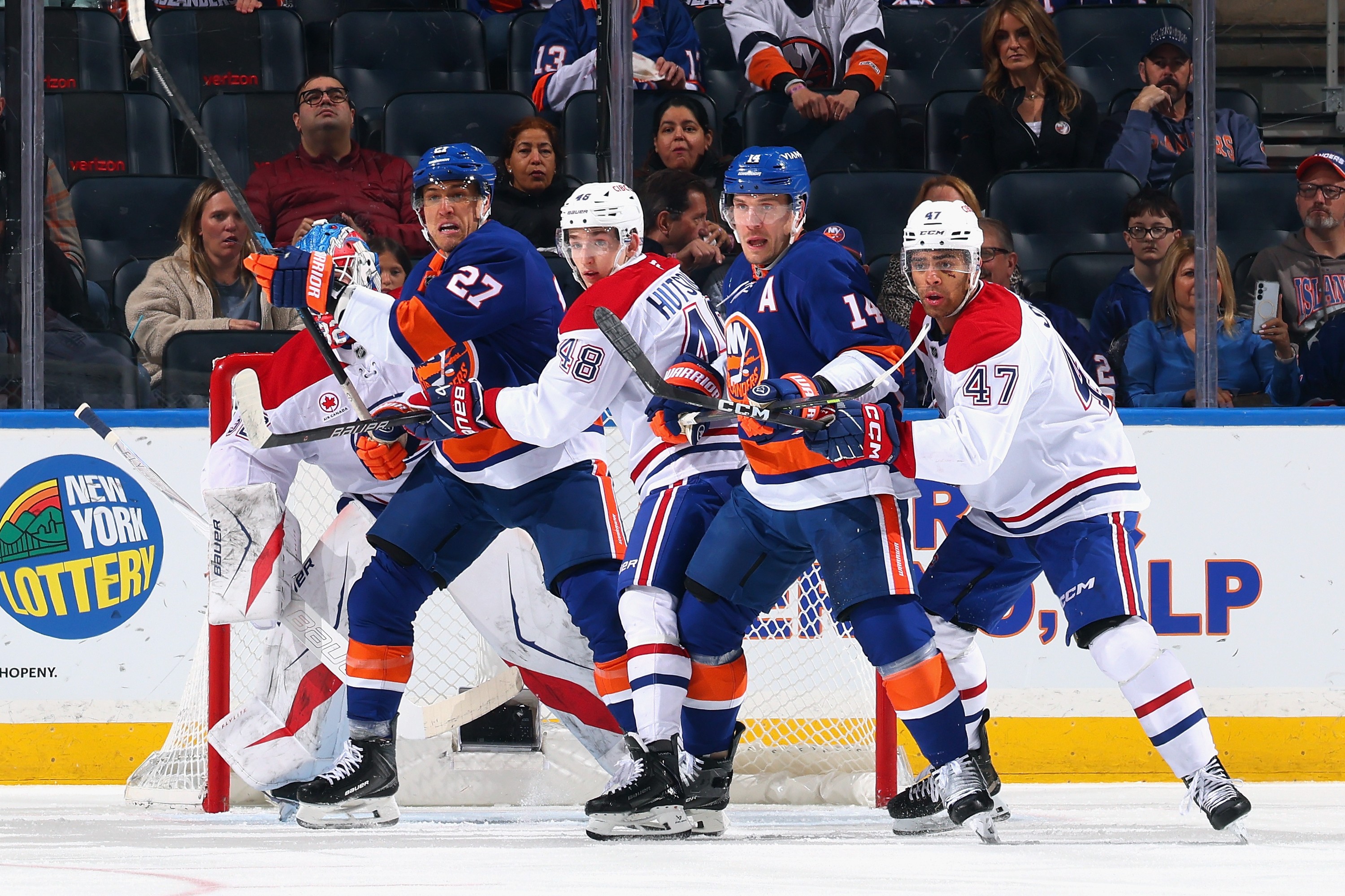 Lane Hutson and Jayden Struble of the Montreal Canadiens defend against the New York Islanders.