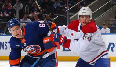 David Reinbacher of the Montreal Canadiens checks Calum Ritchie of the New York Islanders.