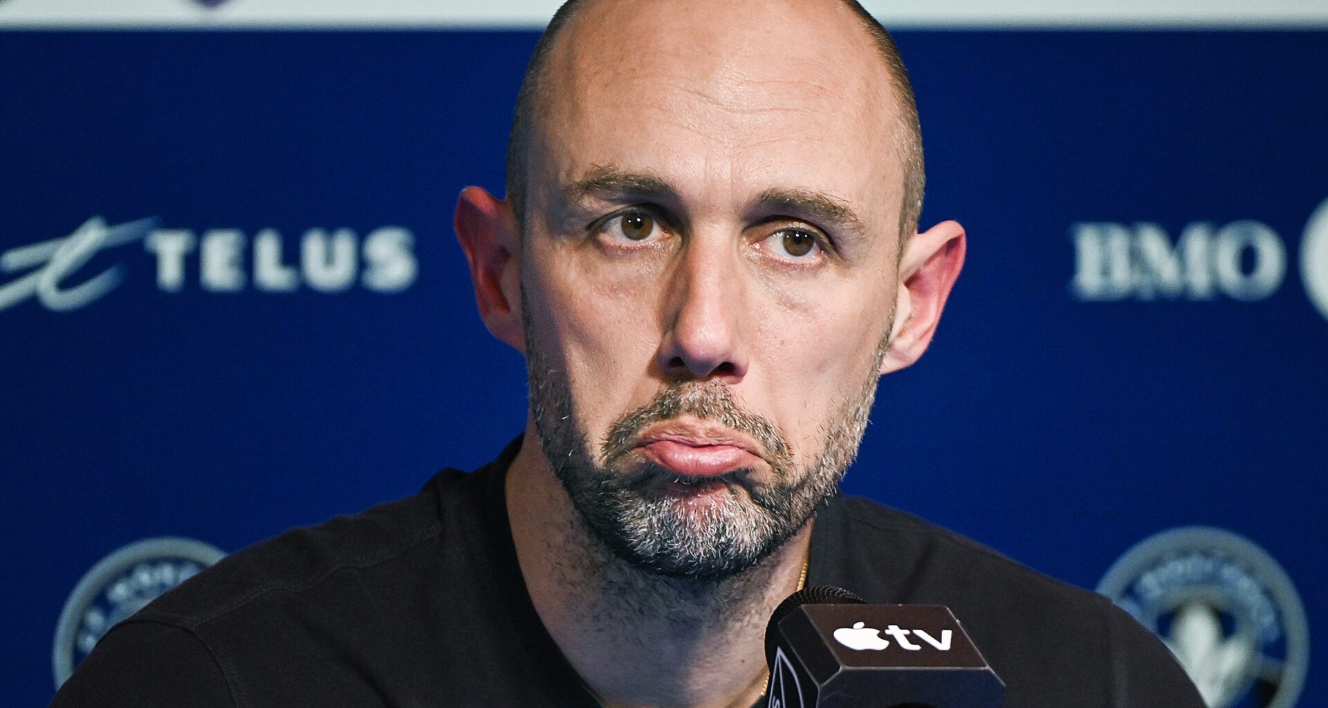 Former CF Montréal head coach Marco Donadel frowns during a press conference.