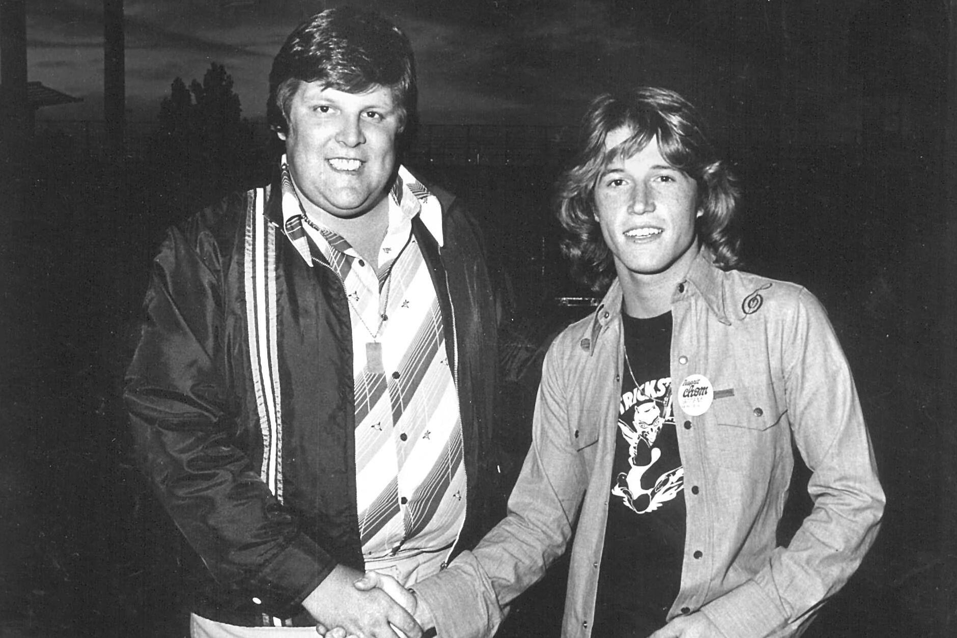Promoter Donald Tarlton with Andy Gibb in a black and white photo.
