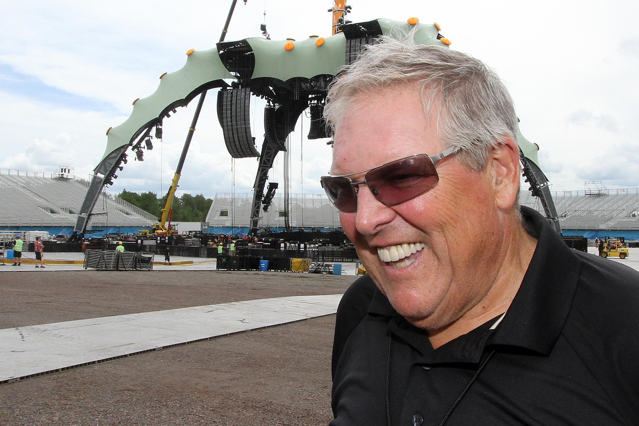 Promoter Donald Tarlton in front of the stage setup for a U2 concert.