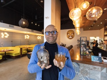 Alejandro Diaz with a special El Santo drink inside the restaurant in New Westminster.