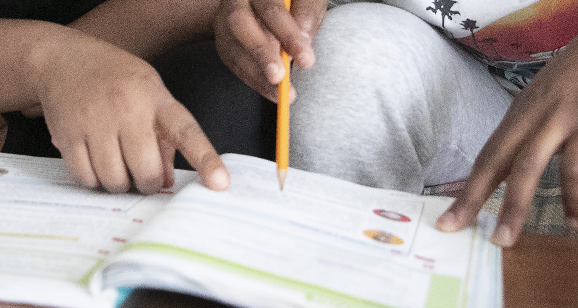 close up of hands over a school book