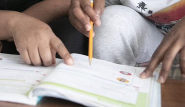 close up of hands over a school book