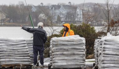 Pallets of sandbags used to make a dike against the rising Rivière des Prairies can be seen in this file photo from 2023.