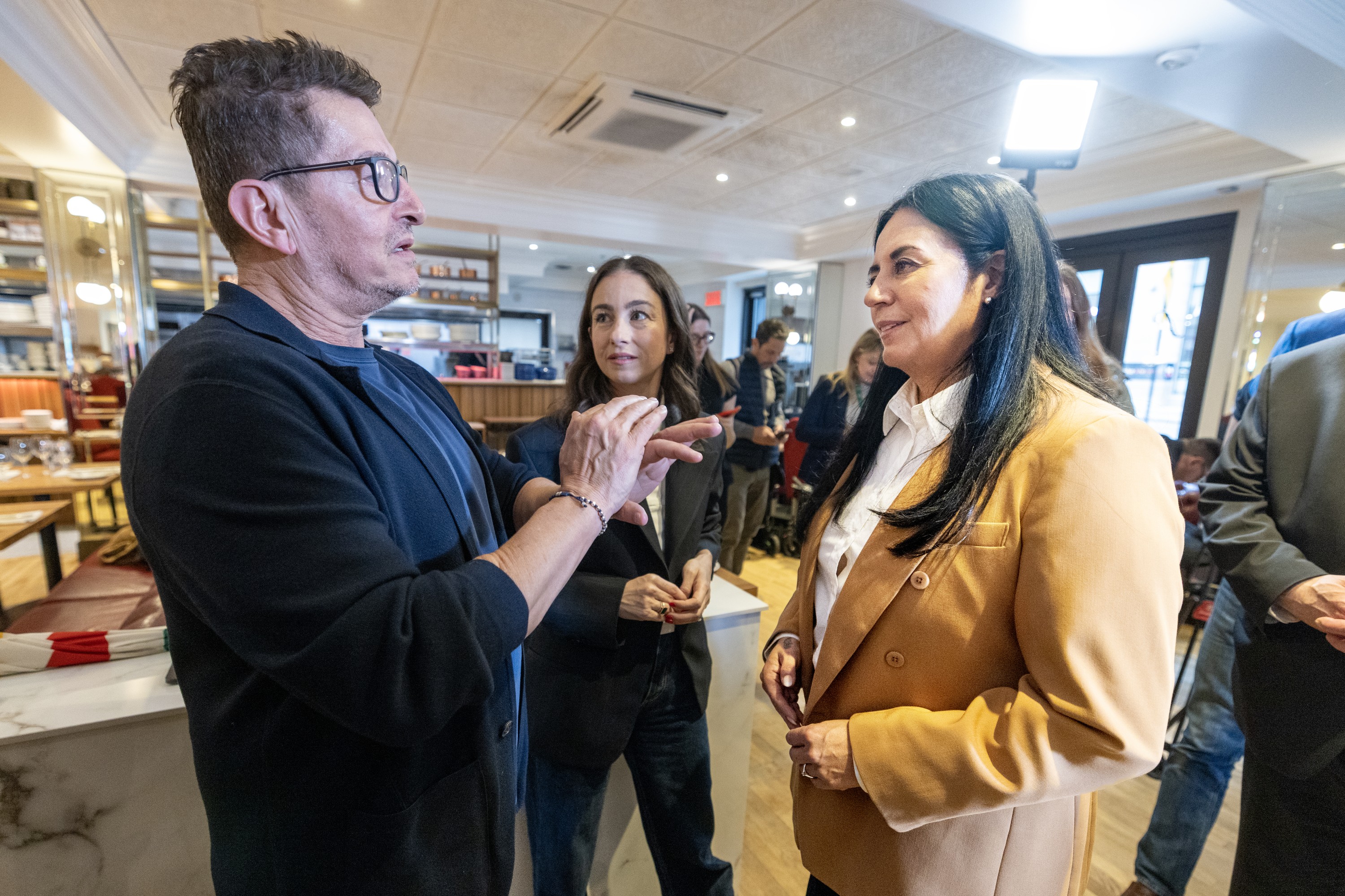 Restaurant owner, right, speaks to Montreal's mayor on the city's announcement of reduced terrace fees.