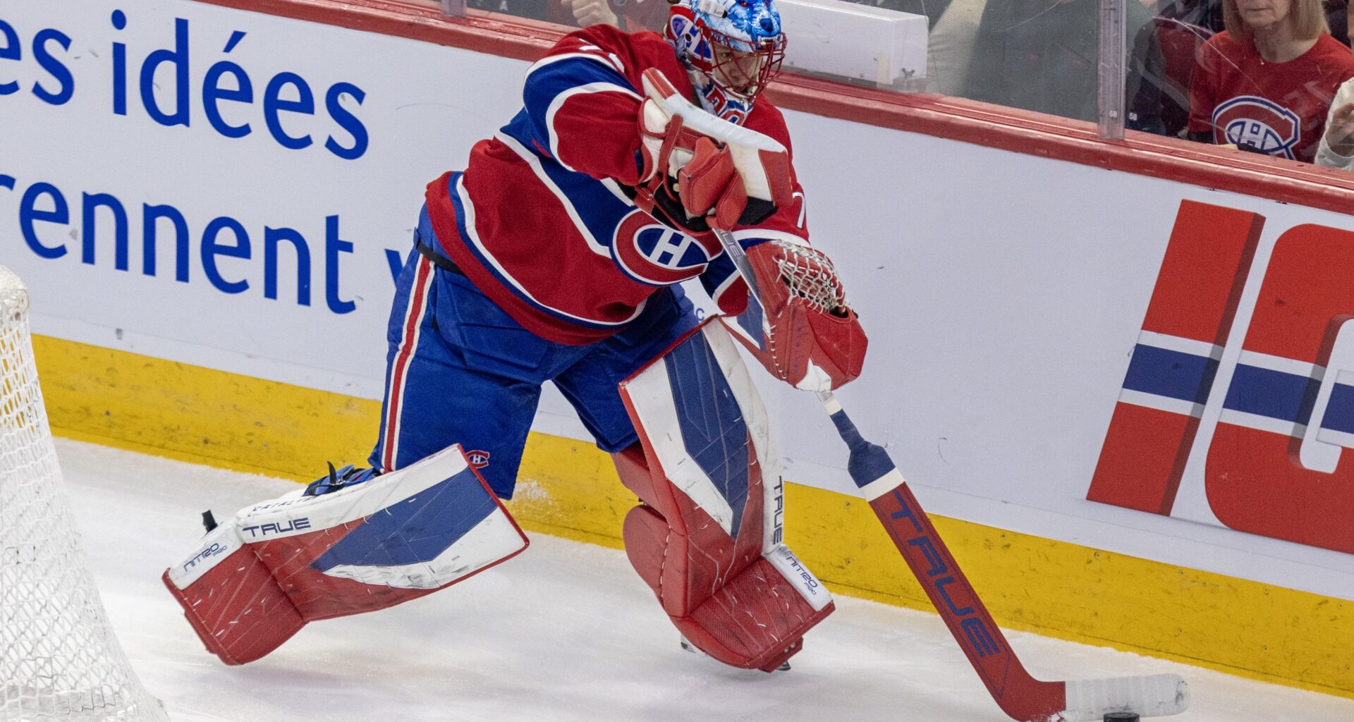 Jakub Dobes is seen playing the puck behind his own net.