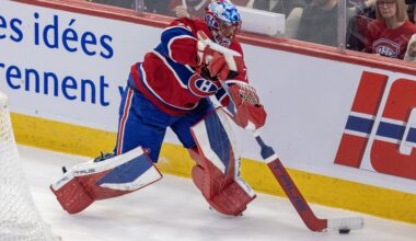 Jakub Dobes is seen playing the puck behind his own net.
