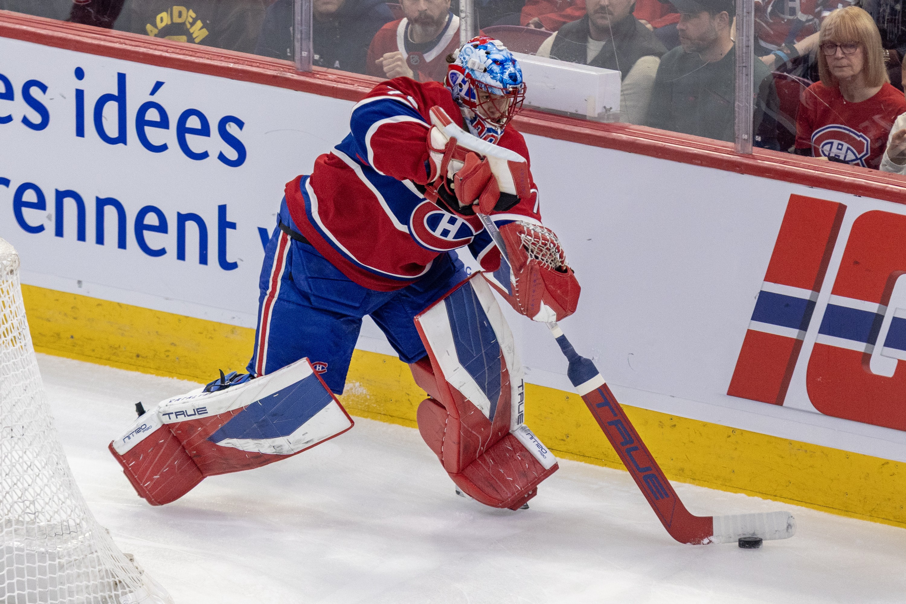 Jakub Dobes is seen playing the puck behind his own net.