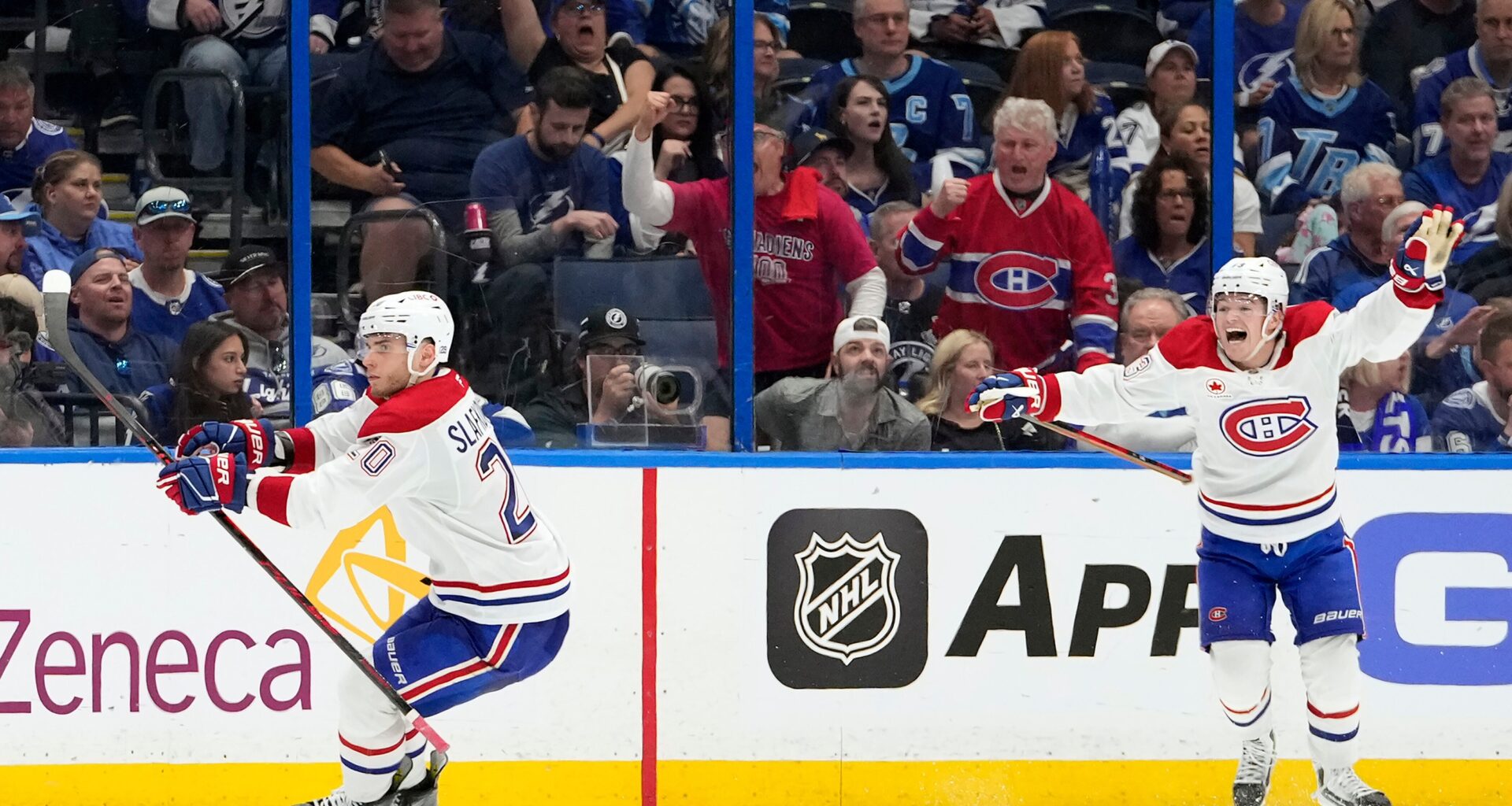 Canadiens wingers Juraj Slafkovsky, left, and Cole Caufield celebrate Slafkovsky
